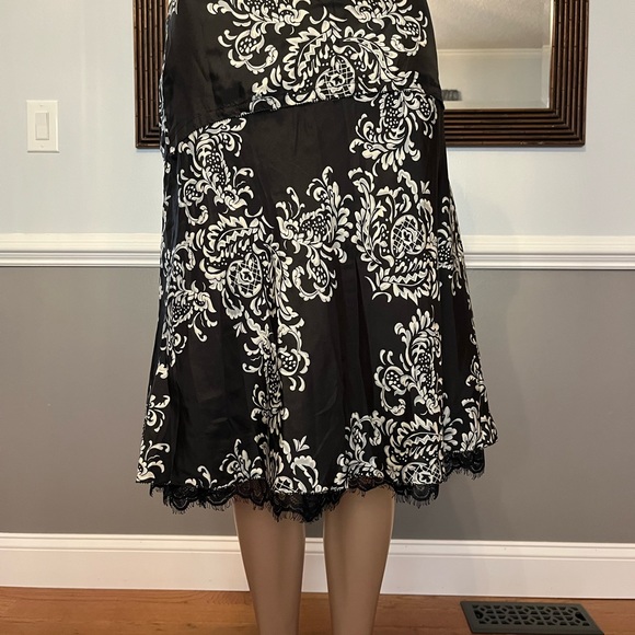 White House Black Market Dresses & Skirts - White House black market high low 100% silk skirt with lace trim.